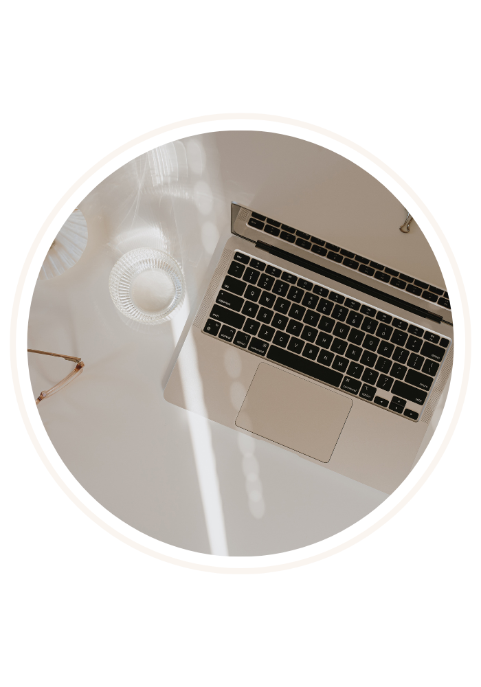 Laptop with a glass of water on the table